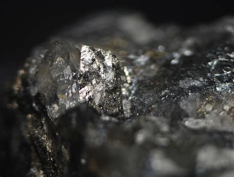 Usually found as matte-black powdery to fibrous crusts, sometimes in botryoidal aggregates or columnar, more rarely as druzes of small prismatic to tabular, dark grey metallic crystals. May be confused with some manganese oxides such as todorokite (fibrous variants) and manganite (tabular crystals). NOTE: No valid pyrolusite dendrites are known.